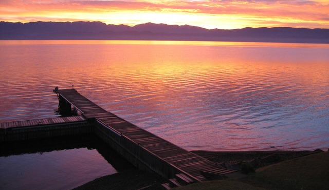 Just steps from Flathead Lake's shore, this fine home offers dock, views, value.